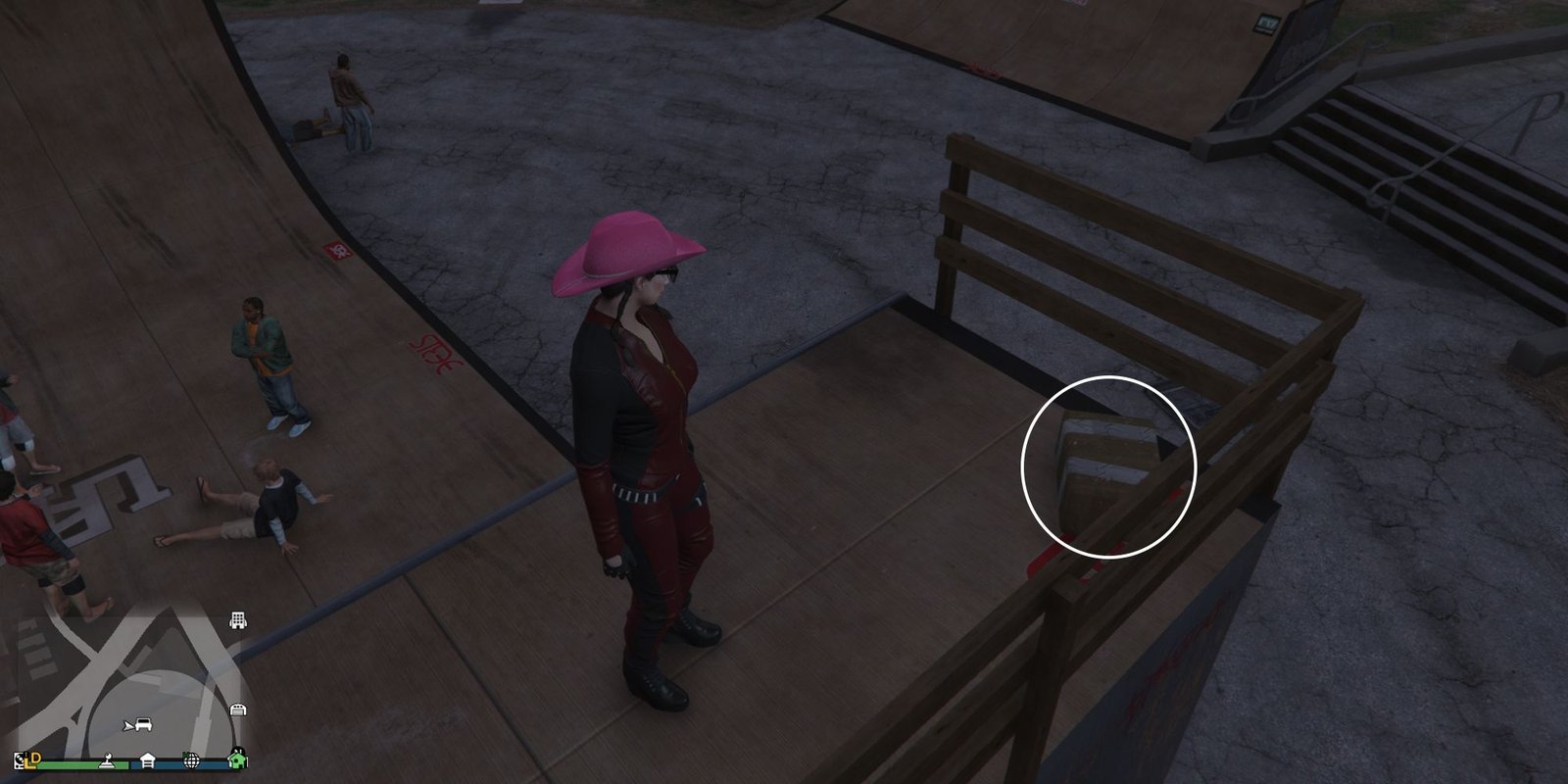 Image depicts a female player in GTA Online at Decker Park on top of the full-ramp in the skate park. There are several NPC's sat on the ramp and skateboarding. At the top of the ramp, G's Cache is sat.