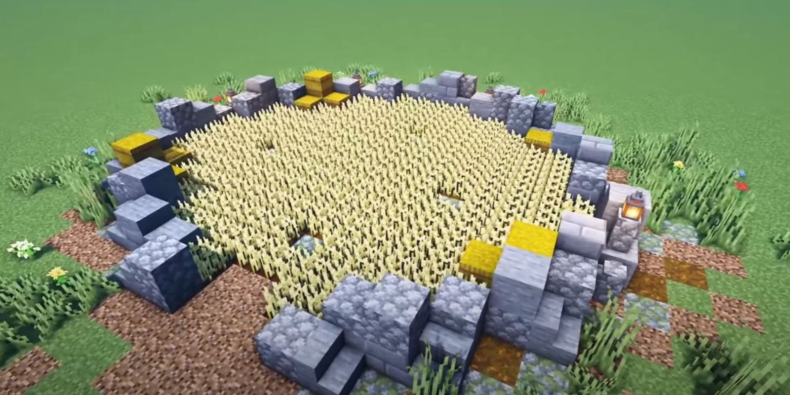 An image from Minecraft of a wheat field surrounded by cobblestone blocks, lamps, and wheat blocks. 