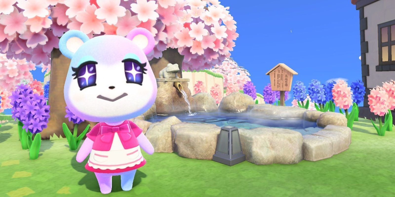 Judy stands by a pond beneath a cherry-blossom tree.