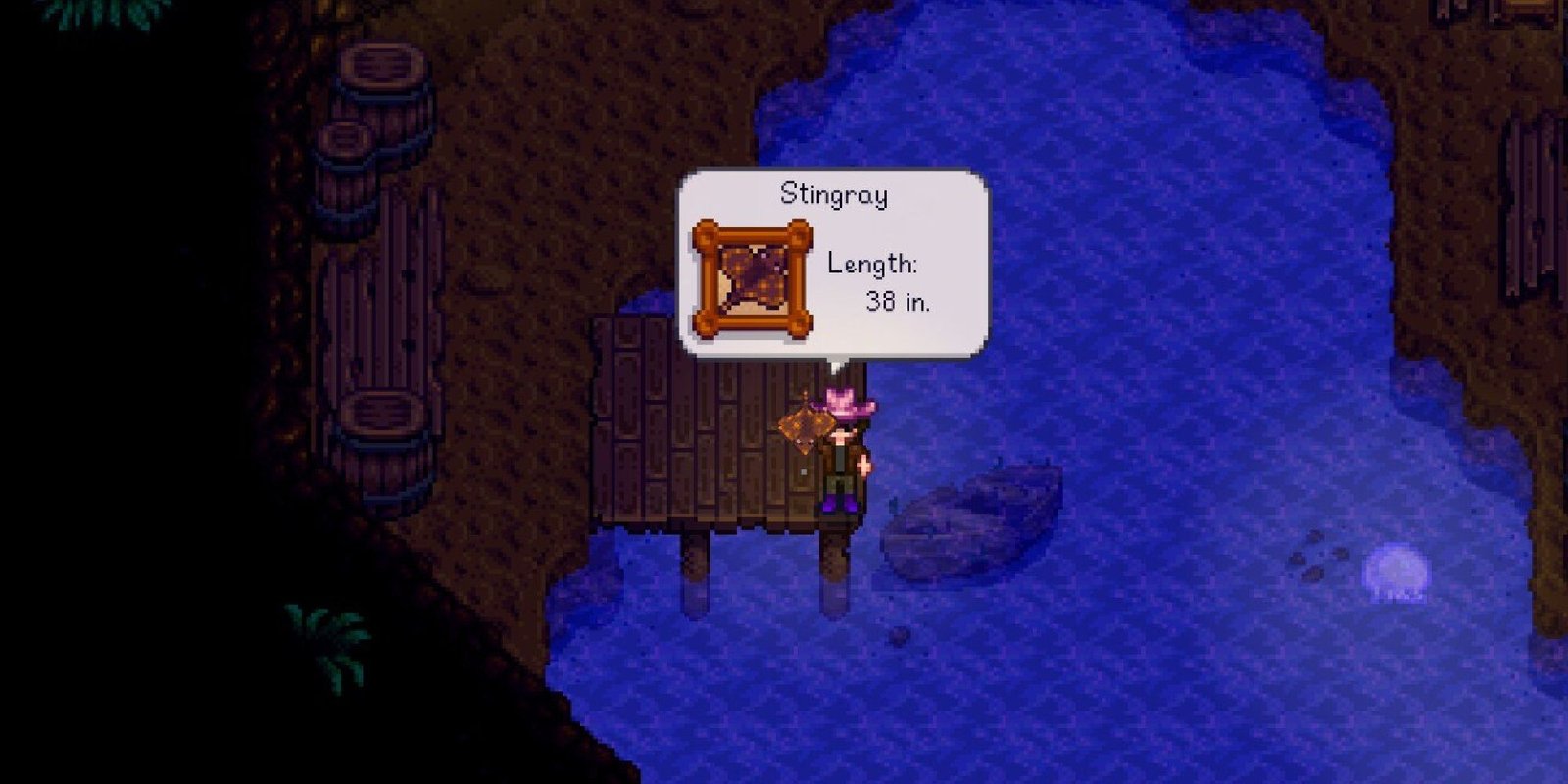 stardew valley player holding a stingray fish on a dock in underground lake