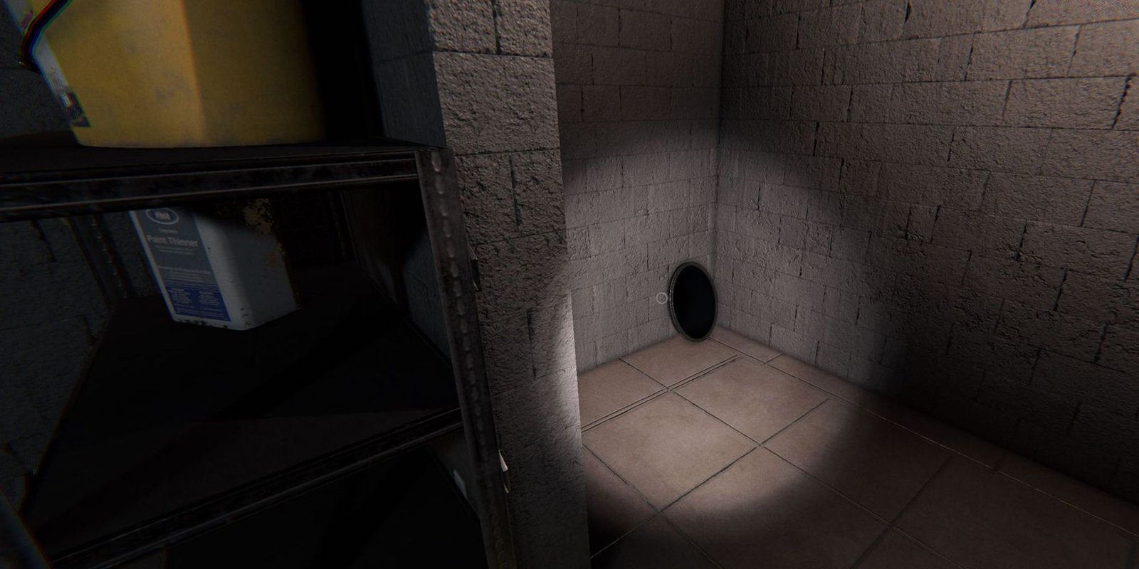 Image depicts a haunted mirror on the ground in the garage of Willow Street in Phasmophobia.