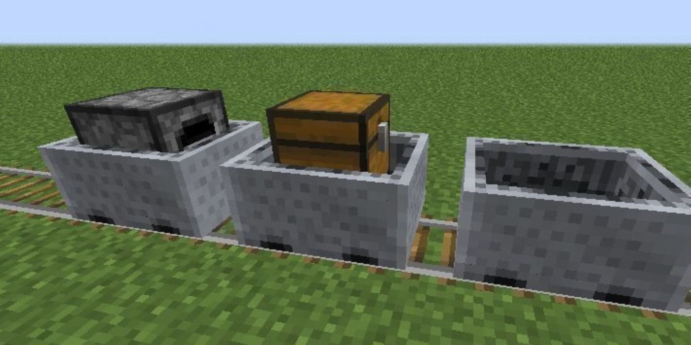 Three minecarts in a rows, with one holding a chest and one holding a furnace. 