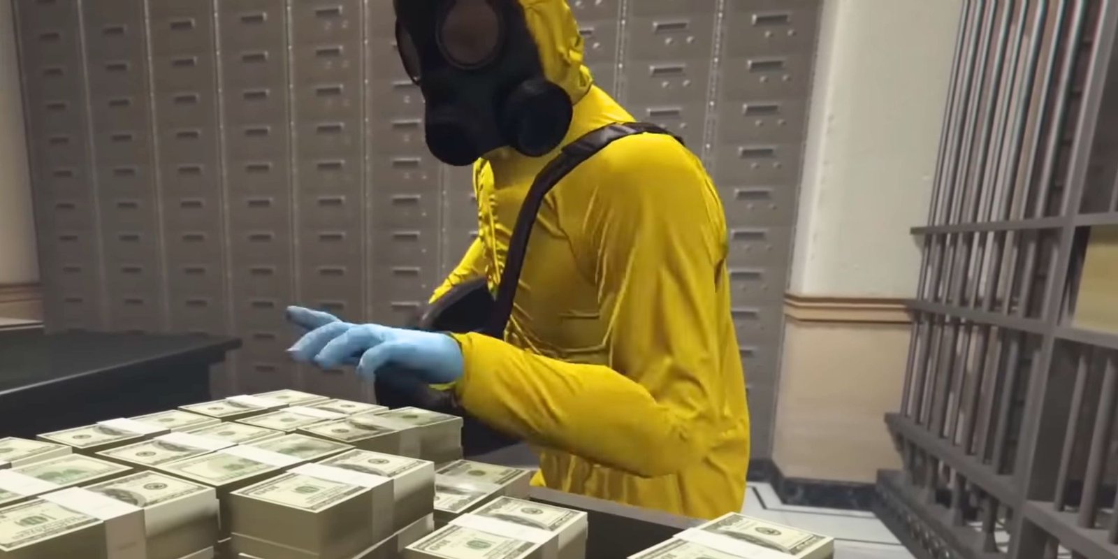 A man in a hazmat suit grabbing a pile of money