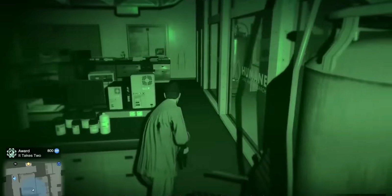 Night Vision view of a man holding a gun and infiltrating a research lab