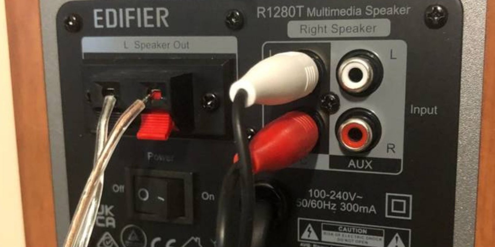 The wiring connections from the back of an Edifier 1280T speaker.