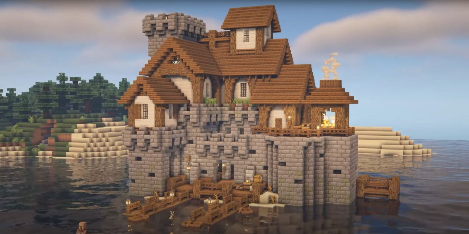 An image from Minecraft of a castle constructed on a small island. This Island Castle is made out of a deep lower layer of stone brick, with an upper level made up of concrete and spruce planks