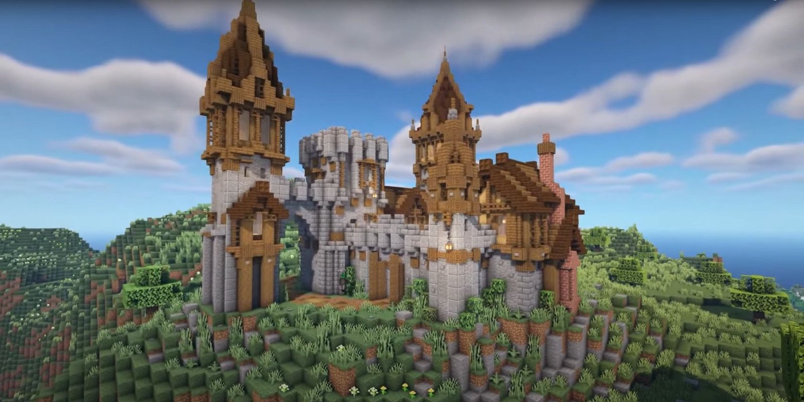 An image from Minecraft of a  Hilltop Castle. This classic castle is made out of stone bricks, with the roofs made out of spruce and dark oak planks. Unlike other castles, this one has multiple towers and dedicated structures to make it appear unique. 