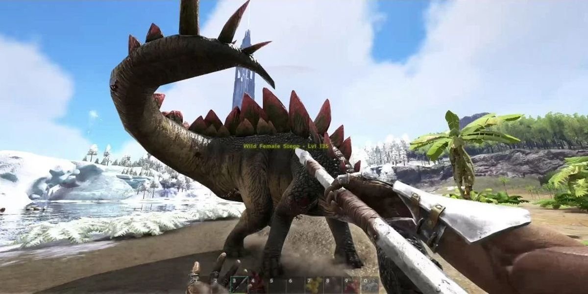 The protagonist of Ark Survival Evolved using a pike to fend off a dinosaur on a beach.