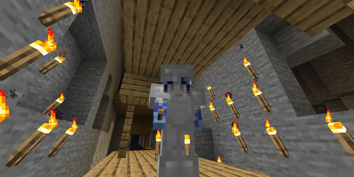 Minecraft torches are placed around a player in a mine.