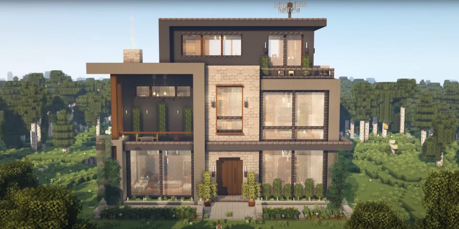 An image from Minecraft of a large Modern House. This structure is made out of different gray concerte and stone bricks, to provide a smooth and contemporary feeling to the build.