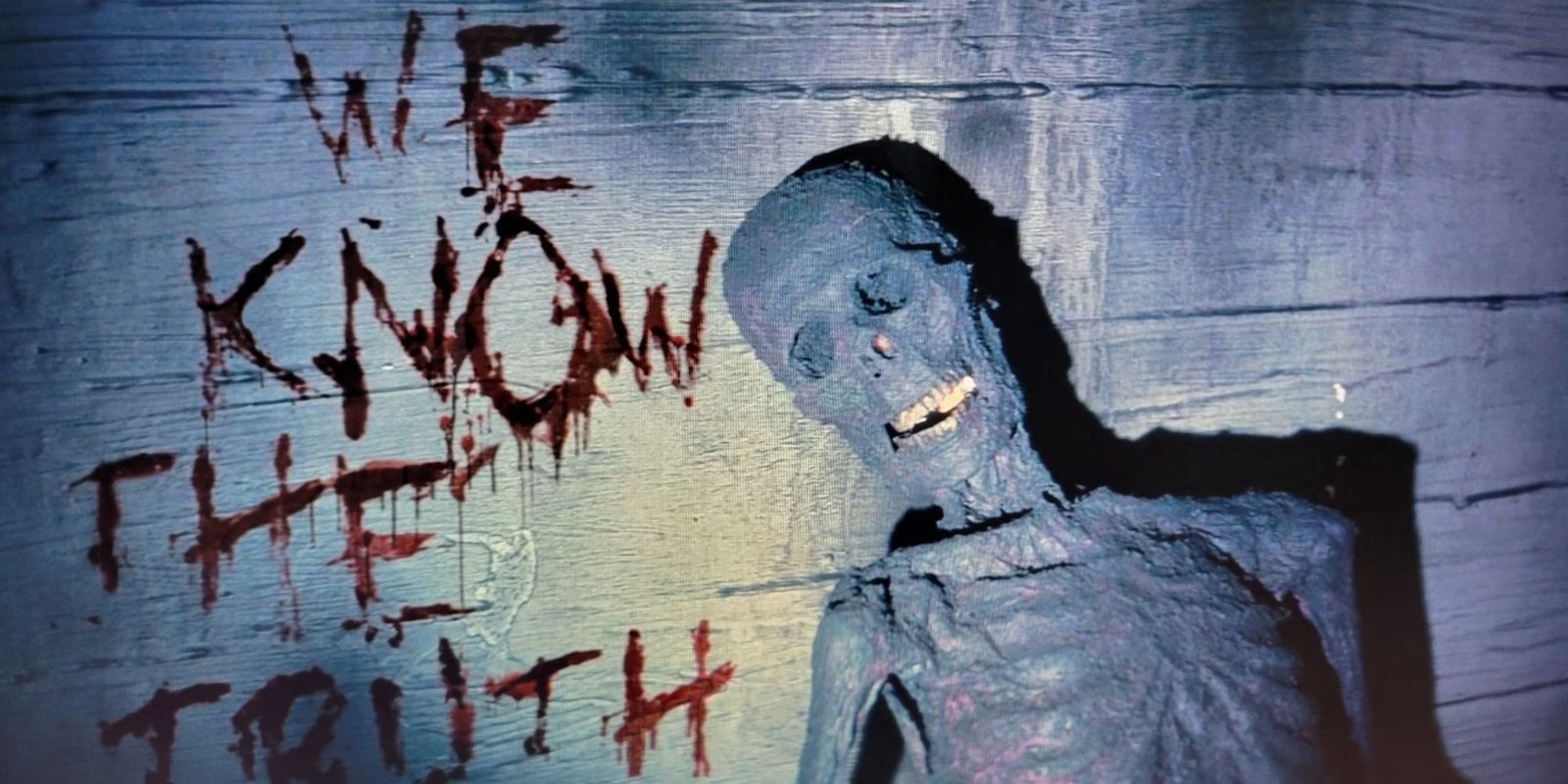 Fallout TV series old skeletal corpse in front of a wooden wall with We Know The Truth written in blood